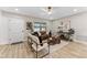 Bright living room with modern furnishings, wood-look floors, and a cozy seating arrangement perfect for entertaining at 7494 7Th N St, St Petersburg, FL 33702