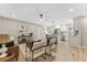 Open-concept living room flows into a modern kitchen with stainless steel appliances and a center island at 7494 7Th N St, St Petersburg, FL 33702