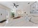Spacious bedroom with plank flooring, modern decor, natural light, and open layout to Primary bathroom at 7494 7Th N St, St Petersburg, FL 33702