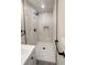 This is a neutral-toned shower featuring light tile and a rainfall shower head at 7494 7Th N St, St Petersburg, FL 33702