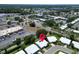 Aerial view showcasing a neighborhood close to roads, commercial buildings, and green spaces indicating a vibrant location at 9136 42Nd N Ln, Pinellas Park, FL 33782