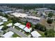 Aerial view showcasing a neighborhood close to commercial buildings, and roads indicating a vibrant, accessible location at 9136 42Nd N Ln, Pinellas Park, FL 33782