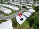 An aerial view of a neighborhood showcasing single-story homes, lush landscaping, and a calm, suburban atmosphere at 9136 42Nd N Ln, Pinellas Park, FL 33782