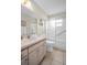 Bathroom with tiled floor, vanity with cabinets, and shower with sliding glass doors at 9136 42Nd N Ln, Pinellas Park, FL 33782