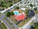 Aerial view of the community pool, clubhouse and recreation area with mature trees and parking at 9136 42Nd N Ln, Pinellas Park, FL 33782