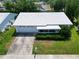 A charming single-story home featuring a well-manicured lawn and concrete driveway leading to an attached garage at 9136 42Nd N Ln, Pinellas Park, FL 33782