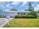 Charming home featuring a well-maintained lawn and a welcoming front entrance at 9136 42Nd N Ln, Pinellas Park, FL 33782