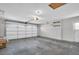 Spacious two car garage with painted concrete floors and white garage door at 9136 42Nd N Ln, Pinellas Park, FL 33782