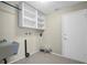 Laundry room features a utility sink, overhead storage, and tile flooring at 9136 42Nd N Ln, Pinellas Park, FL 33782