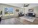 Bright living room featuring hardwood floors, large windows, and stylish decor at 9136 42Nd N Ln, Pinellas Park, FL 33782