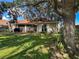Enjoy a tranquil backyard with patio, lush lawn, and plenty of shade under a mature tree at 923 Tuscanny St, Brandon, FL 33511