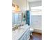 Bright bathroom featuring a white vanity with marble countertop, stylish fixtures, and tub with tiled walls at 923 Tuscanny St, Brandon, FL 33511