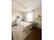 Charming bedroom featuring a floral-patterned bedspread, light blue curtains, and matching nightstand for a serene feel at 923 Tuscanny St, Brandon, FL 33511