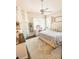 Cozy bedroom features a large bed, vanity, neutral color scheme and a bright window overlooking the backyard at 923 Tuscanny St, Brandon, FL 33511