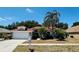 Charming single-story home featuring a well-manicured lawn, palm trees, and an attached two-car garage at 923 Tuscanny St, Brandon, FL 33511