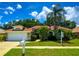 Charming single-story home featuring a well-manicured lawn, mature palm trees, and a welcoming front entrance at 923 Tuscanny St, Brandon, FL 33511