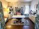 Bright home office with built-in bookshelves, a large desk, and a chandelier for focused productivity at 923 Tuscanny St, Brandon, FL 33511
