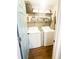 Efficient laundry room with washer, dryer, and shelving for storage, offering convenience and organization at 923 Tuscanny St, Brandon, FL 33511