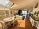 Open-concept living space with ample seating, wood flooring, a skylight, and access to the outdoors at 923 Tuscanny St, Brandon, FL 33511