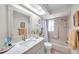 Updated bathroom featuring vanity, framed mirror, shower-tub combo, and modern toilet at 9335 Stonewall, New Port Richey, FL 34655