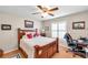 Bedroom featuring a ceiling fan, hardwood floors, desk, and bright, natural light at 9335 Stonewall, New Port Richey, FL 34655