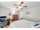 Bright bedroom with ceiling fan, hardwood floors, and furnished with a desk and dresser at 9335 Stonewall, New Port Richey, FL 34655