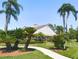 An inviting clubhouse framed by swaying palms and lush landscaping, beckoning relaxation and community engagement at 9335 Stonewall, New Port Richey, FL 34655