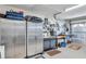 Well-organized garage featuring stainless steel storage cabinets, pegboard, and work bench at 9335 Stonewall, New Port Richey, FL 34655