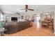 Expansive living area with wood flooring, multiple seating areas, and an open layout perfect for entertaining guests at 9335 Stonewall, New Port Richey, FL 34655