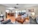 Open-concept living space with wood flooring, multiple seating areas, and ample natural light creating a versatile layout at 9335 Stonewall, New Port Richey, FL 34655