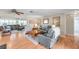 Spacious living area with wood flooring, comfortable seating, and neutral decor creating a relaxing and inviting space at 9335 Stonewall, New Port Richey, FL 34655