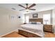 Bedroom featuring a ceiling fan, bedside tables, hardwood floors, and neutral paint at 9335 Stonewall, New Port Richey, FL 34655