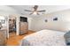 Bedroom with ceiling fan, walk-in closet, television on dresser, and wood floors at 9335 Stonewall, New Port Richey, FL 34655