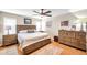 Spacious main bedroom featuring wood floors, a ceiling fan, and a full, matching furniture set at 9335 Stonewall, New Port Richey, FL 34655