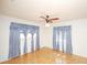 Well-lit bedroom with parquet floors, ceiling fan, and classic style at 934 Jerry Smith Rd, Dover, FL 33527