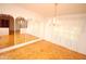 Bright dining room featuring parquet floors, a chandelier and decorative mirror details at 934 Jerry Smith Rd, Dover, FL 33527