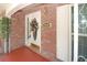 Charming front door with brick exterior and decorative wreath, creating a welcoming entrance at 934 Jerry Smith Rd, Dover, FL 33527