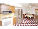 Bright eat-in kitchen with checkered floors, stainless steel appliances, and a cozy dining nook at 934 Jerry Smith Rd, Dover, FL 33527