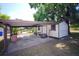 Exterior shed with a covered parking area near the pool at 934 Jerry Smith Rd, Dover, FL 33527