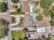 Aerial view showcasing the property's layout, including the home, driveway, and landscaping and pool at 936 Alcazar Way S, St Petersburg, FL 33705