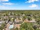 A beautiful aerial view showcases a neighborhood with tree-lined streets and backyard pools at 936 Alcazar Way S, St Petersburg, FL 33705