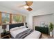 Bright bedroom with large window and stylish decor including a dark green dresser at 936 Alcazar Way S, St Petersburg, FL 33705