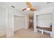 Bright bonus room with a ceiling fan, built-in shelving, and tiled floor at 936 Alcazar Way S, St Petersburg, FL 33705