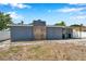 View of the home's exterior, showing an attached covered patio bar area and a stone chimney at 936 Alcazar Way S, St Petersburg, FL 33705