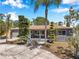 Inviting single-story house featuring a cozy porch and landscaped front yard at 936 Alcazar Way S, St Petersburg, FL 33705