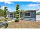 Charming home with a welcoming front porch, landscaping, and a garage at 936 Alcazar Way S, St Petersburg, FL 33705