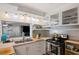 Bright and efficient kitchen with stainless appliances, open shelving, and lots of counter space at 936 Alcazar Way S, St Petersburg, FL 33705