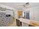 A modern kitchen featuring a breakfast bar, custom shelving, and a stylish design with ample natural light at 936 Alcazar Way S, St Petersburg, FL 33705