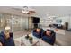 Spacious living room with stone fireplace, large TV, and comfortable seating area at 936 Alcazar Way S, St Petersburg, FL 33705