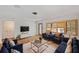 Bright living room with lots of natural light and stylish blue furniture at 936 Alcazar Way S, St Petersburg, FL 33705
